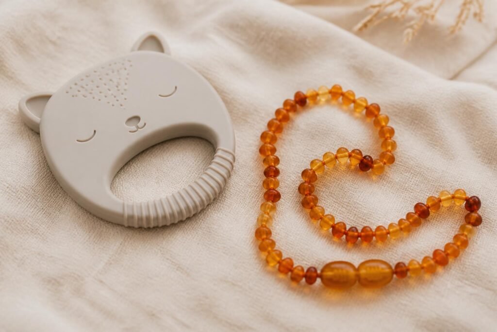 Amber teething necklace next to a safer silicone teether alternative