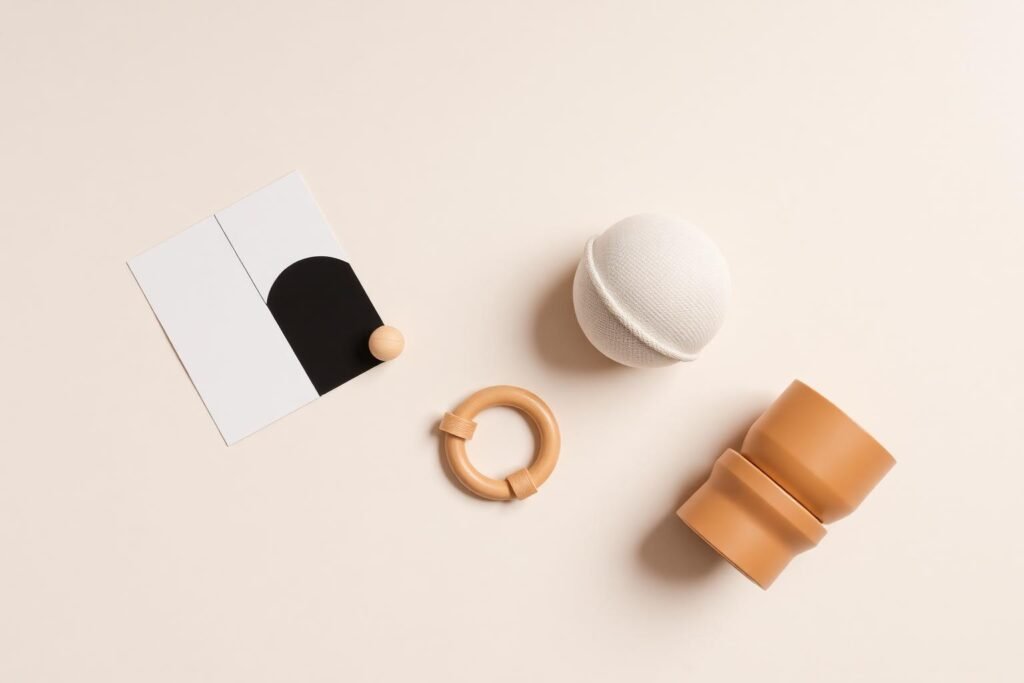 Flat lay of age-appropriate baby activity items for different months of development