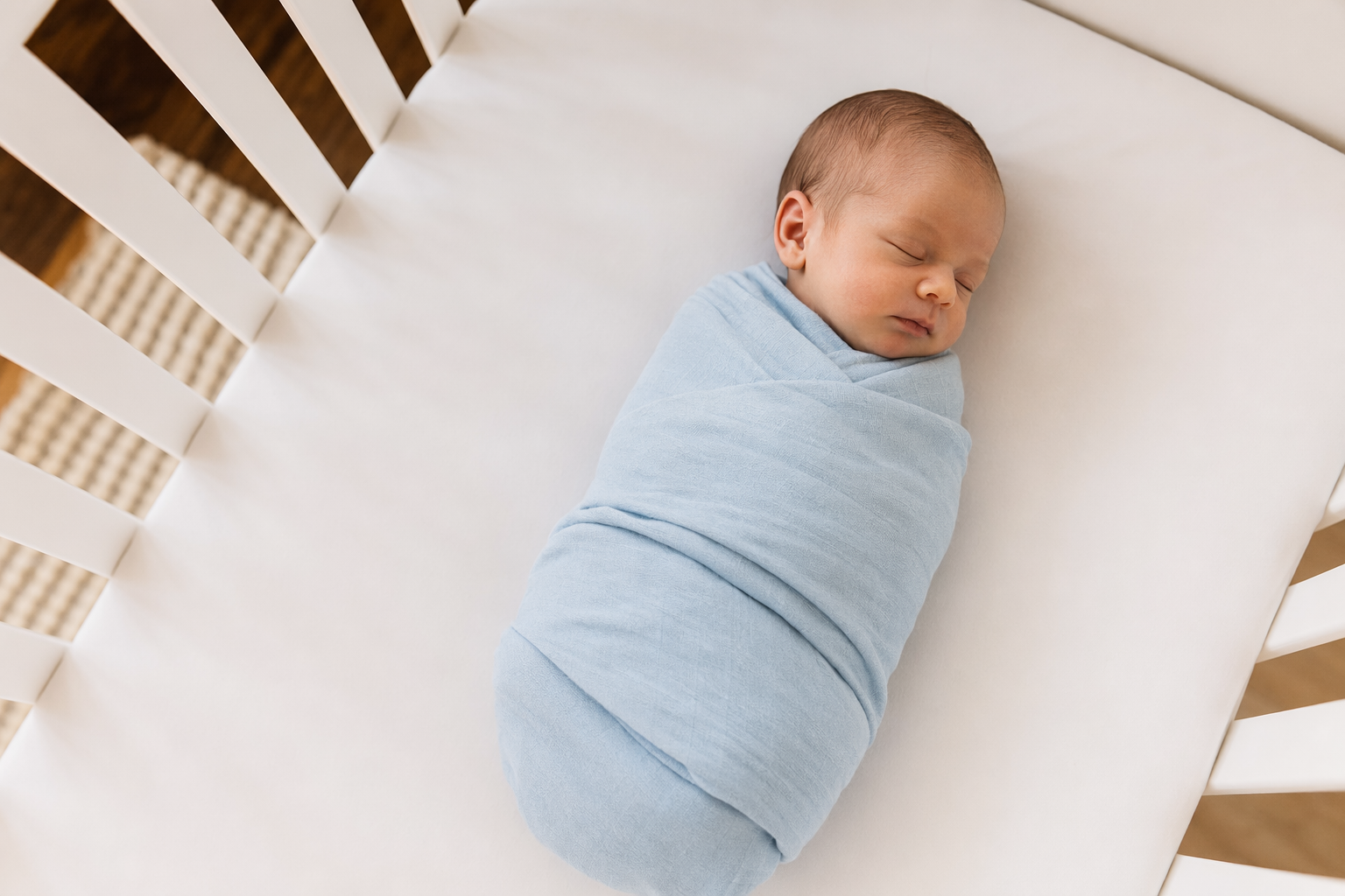 Sleeping newborn baby on back in safe sleep position - baby acid reflux guide